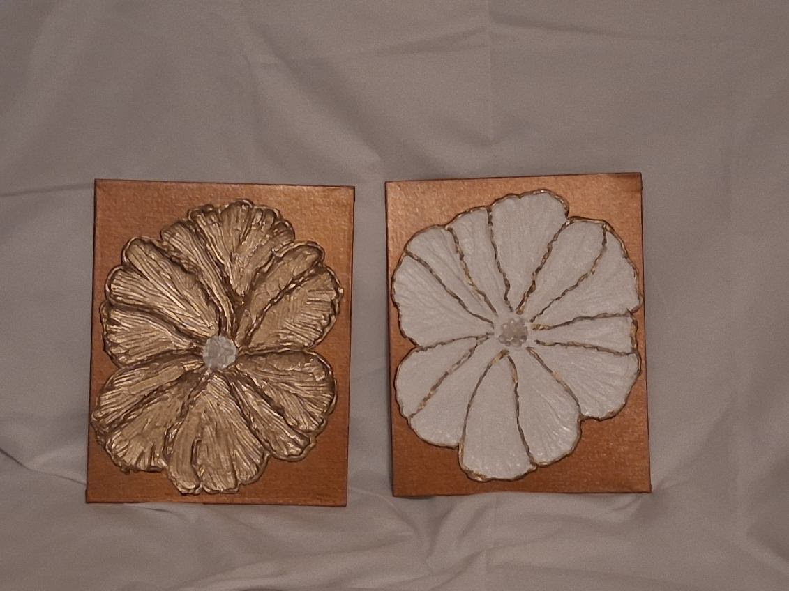 Two floral canvas artworks photographed side by side